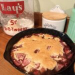 Strawberry shortcake skillet cobbler in a cast iron pan on the counter