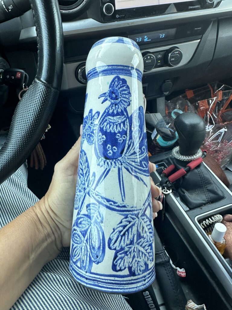 Blue and white Art Nouveau vase held up in the car after a thrift store find