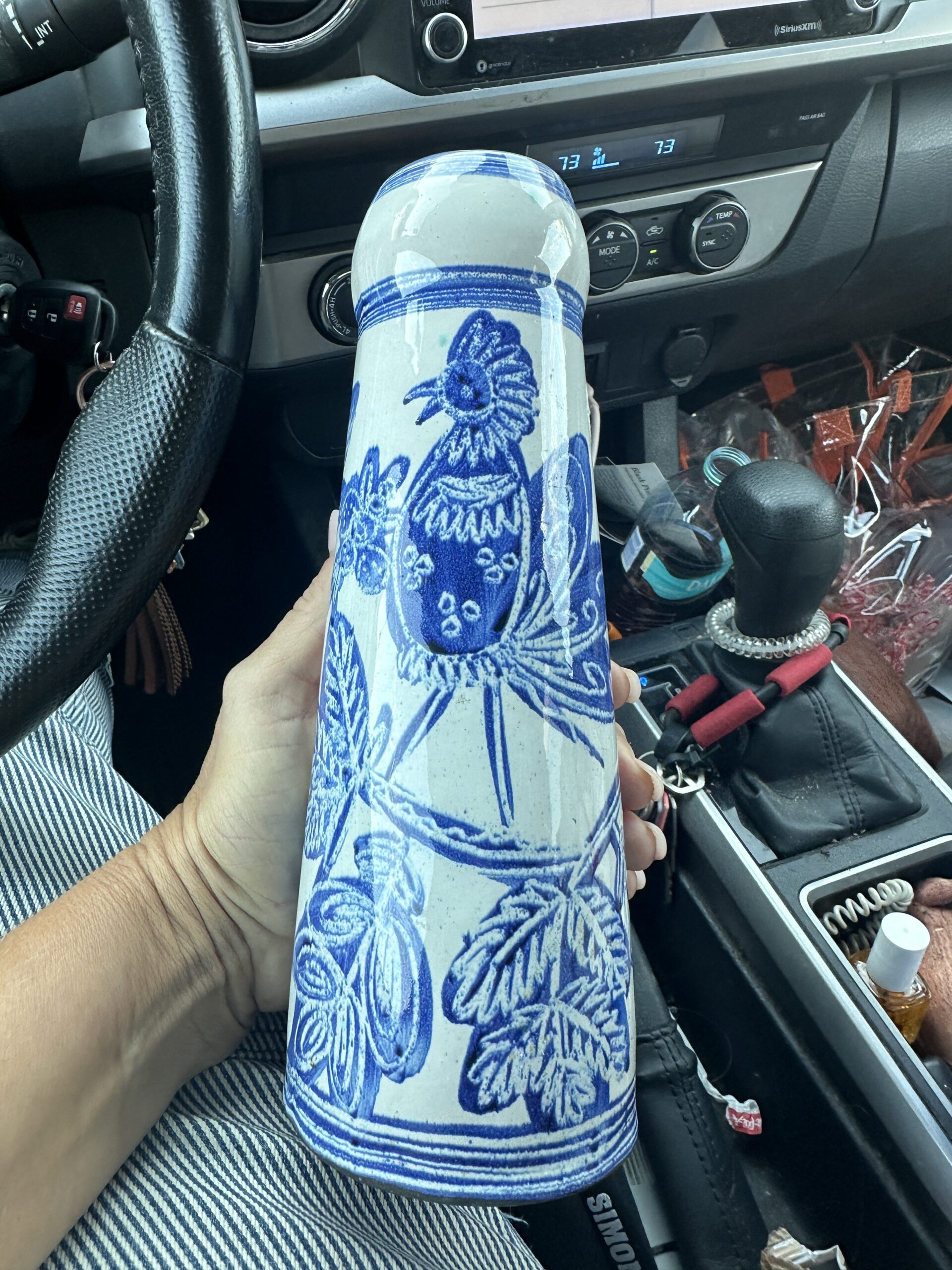 Blue and white Art Nouveau vase held up in the car after a thrift store find