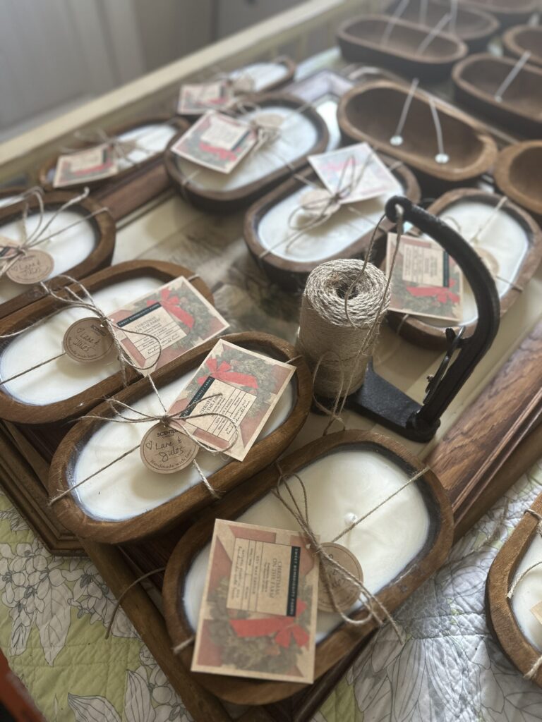 Hand poured soy candles in glass jars with tags, cooling on a table