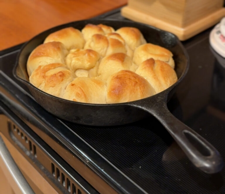 Golden sourdough discard rolls baked in a cast iron skillet