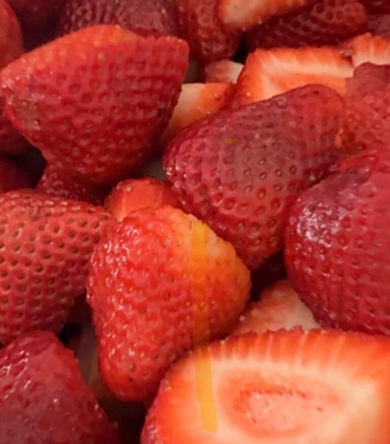 Bowl of fresh strawberries hulled and ready for jam