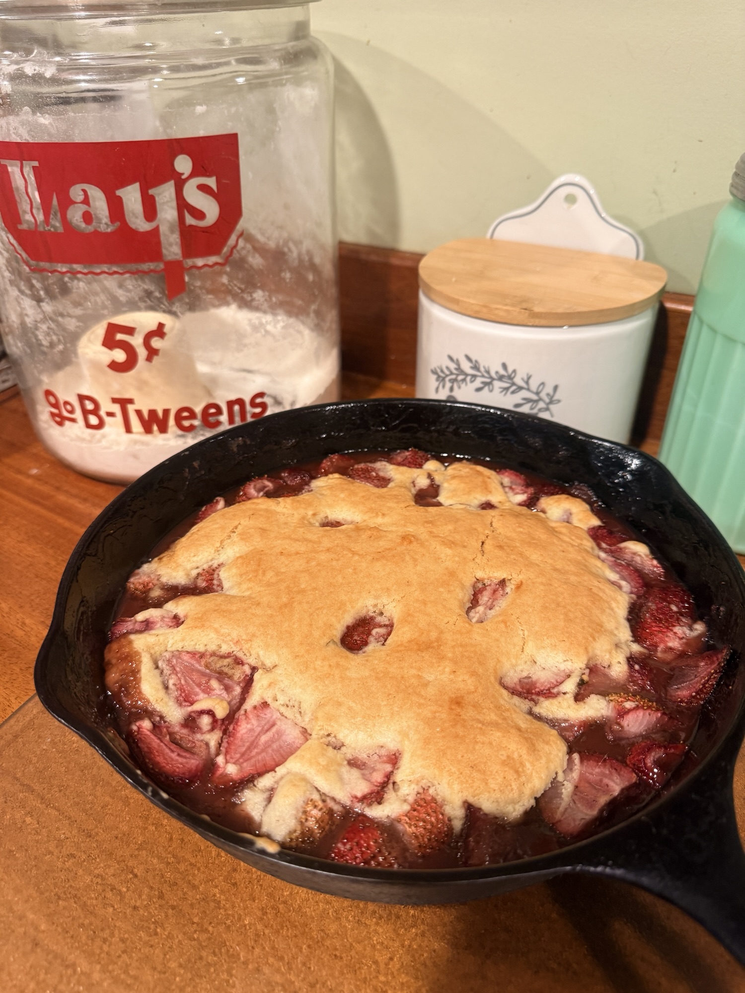 Strawberry shortcake skillet cobbler in a cast iron pan on the counter
