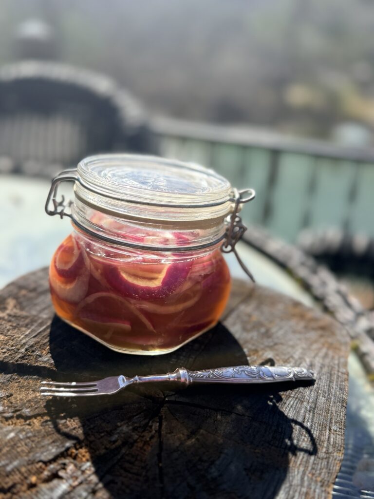 Jar of strawberry preserves cooling on the porch rail