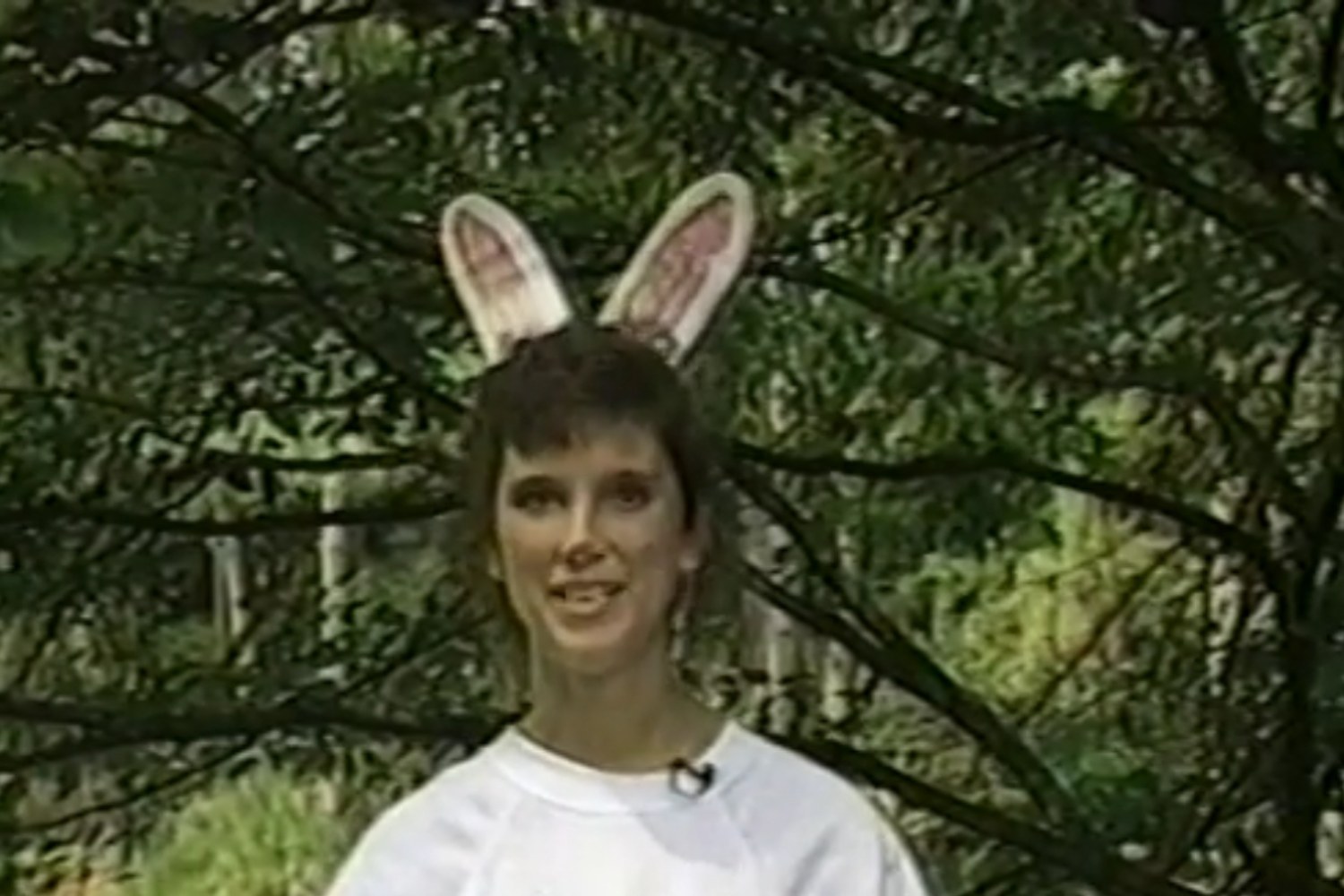 A young Jules, then Julie Koonce, in bunny ears and a white sweatshirt during her first on-camera segment
